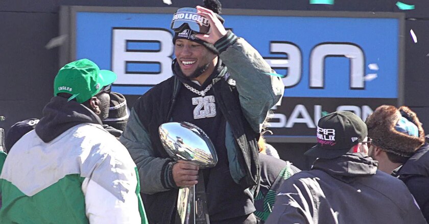 Saquon Barkley spots Eagles ball boy in parade crowd, lifts him over barricades to join the action