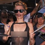Miley Cyrus goes braless in sheer black dress during album promotion