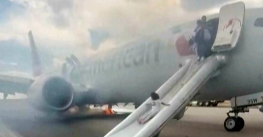 Passengers flee on emergency slide after American Airlines Boeing in Denver suffers landing gear fire