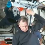 Russian cosmonaut Ivan Vagner wears alien mask while welcoming newcomers