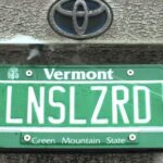 This backup camera cleaner hides behind your license plate